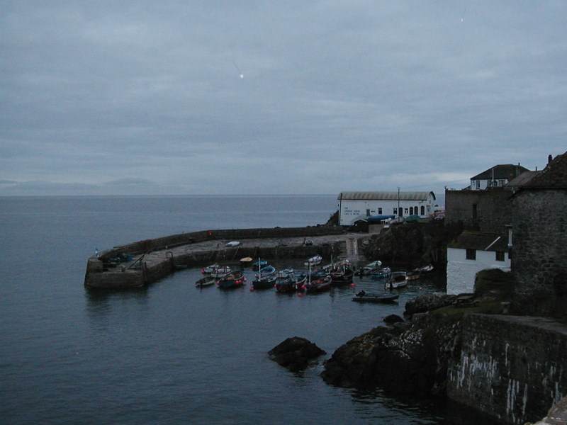 Handful of fishing boats in small harbour.