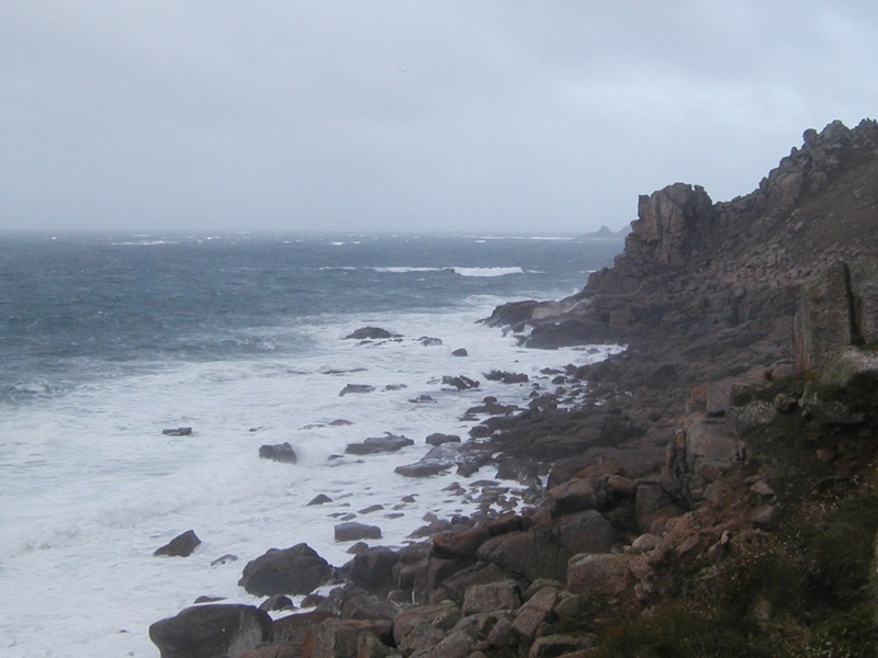 Rugged granite shoreline with rough seas