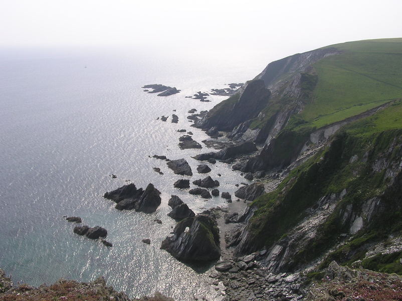 Looking down on shoreline of complex slabs and rocks.