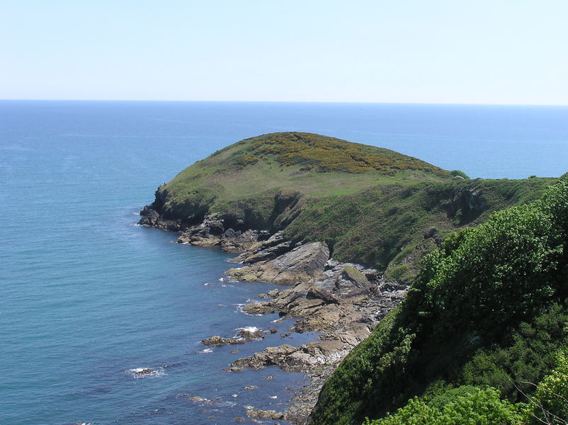 Looking back towards a nice rounded headland, large area of gorse on top.