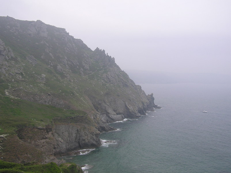 Misty view of headland with sharp spiky rocks.